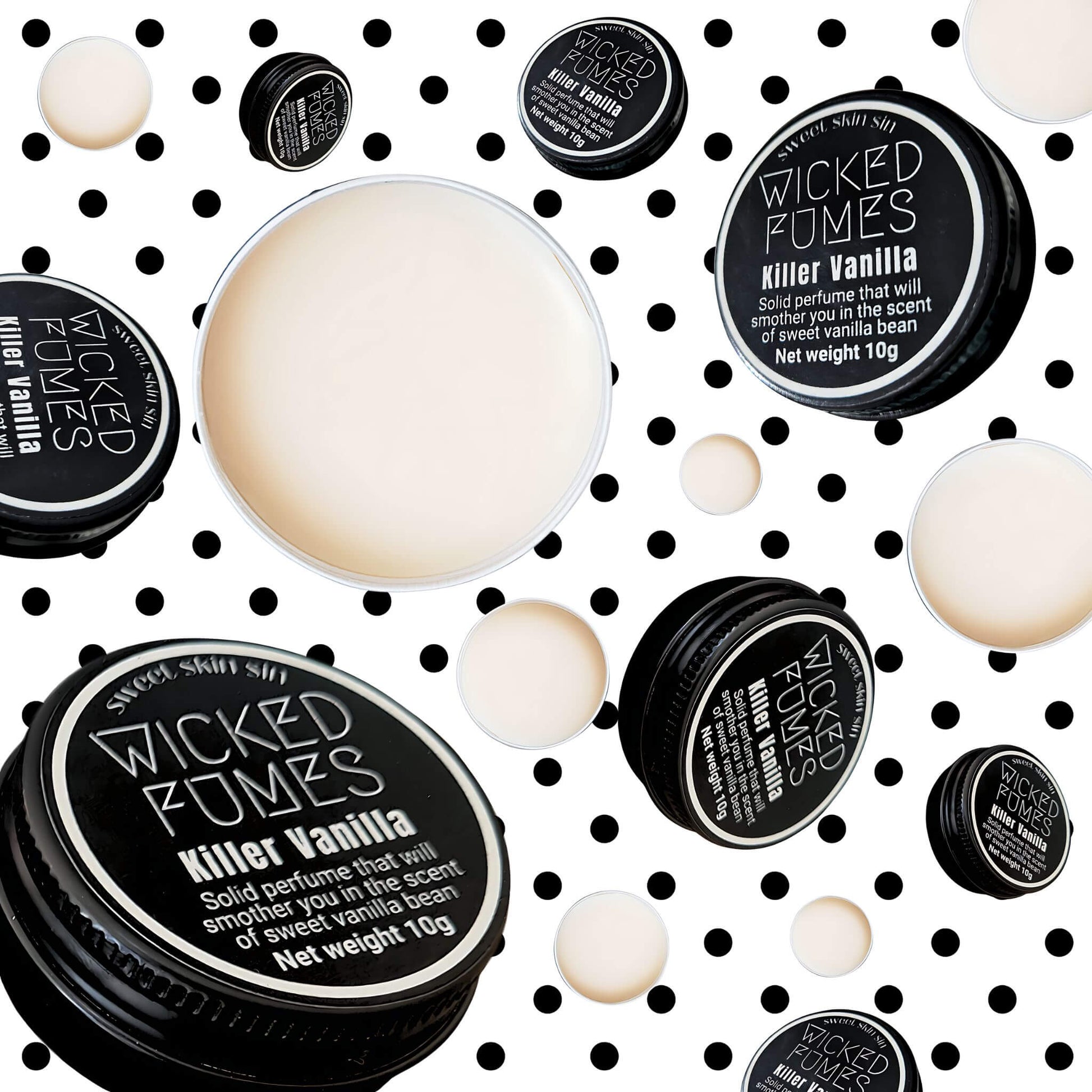killer vanilla tins of solid perfume floating in air on background of black polka dots