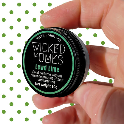 person holding lewd lime perfume in their  hand